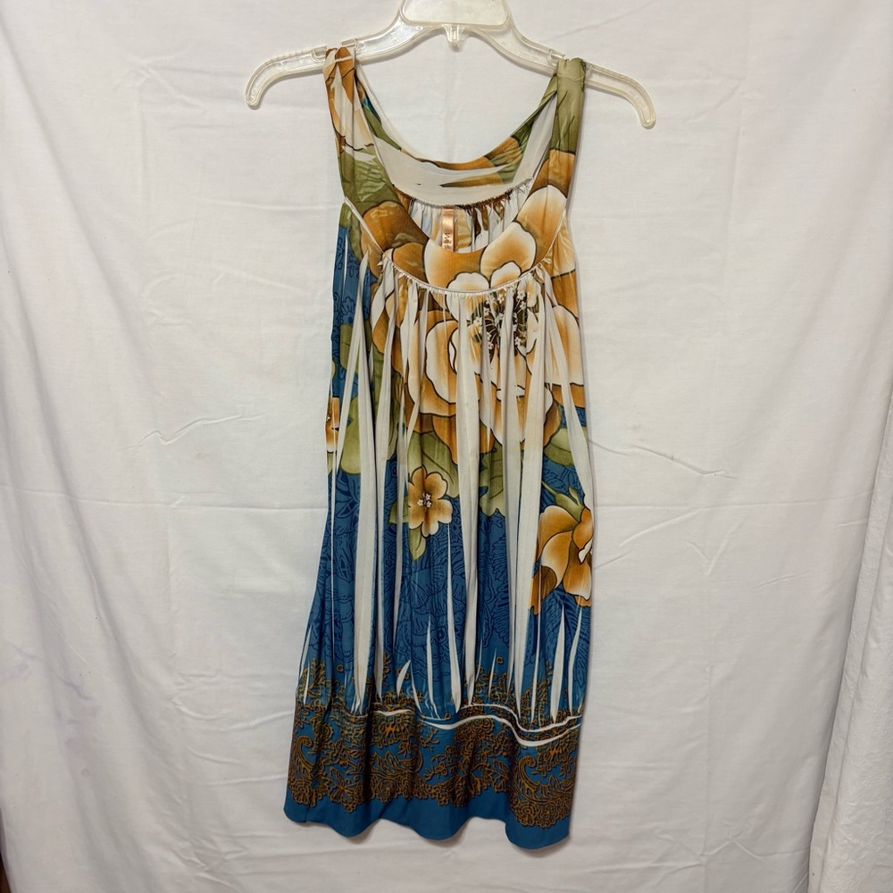 Sleeveless, floral print mini dress with a scoop neck and pleated details.